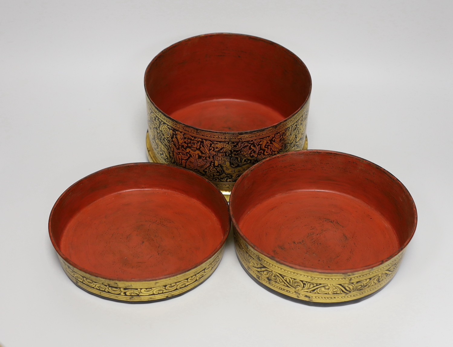 A Burmese gilt decorated papier mache cylindrical box and cover, 14cms high